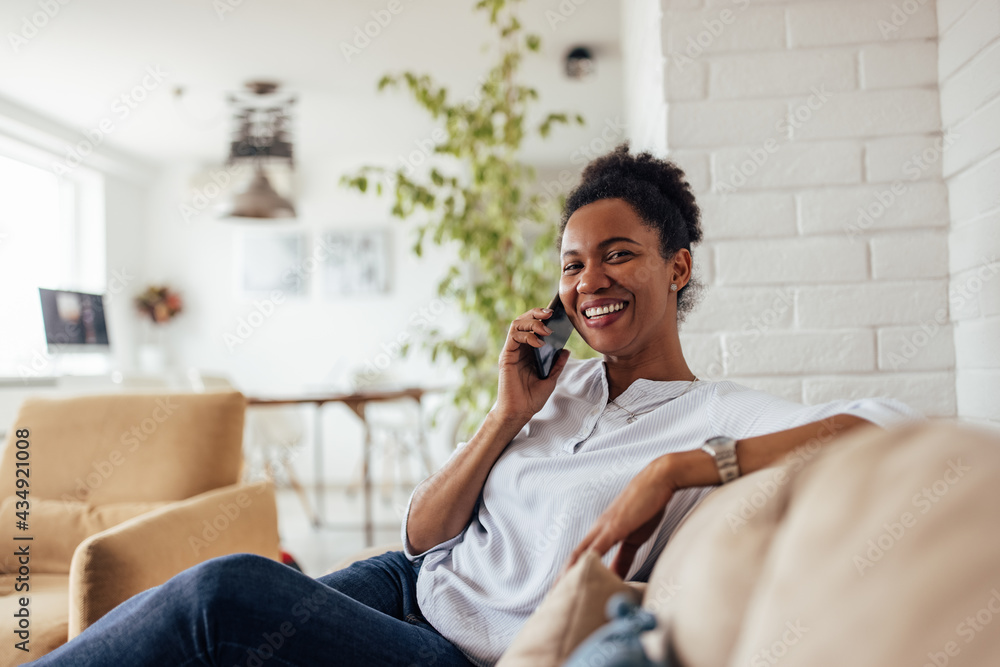 African woman, using mobile phone, talking to someone. African woman, using mobile phone, talking to someone.