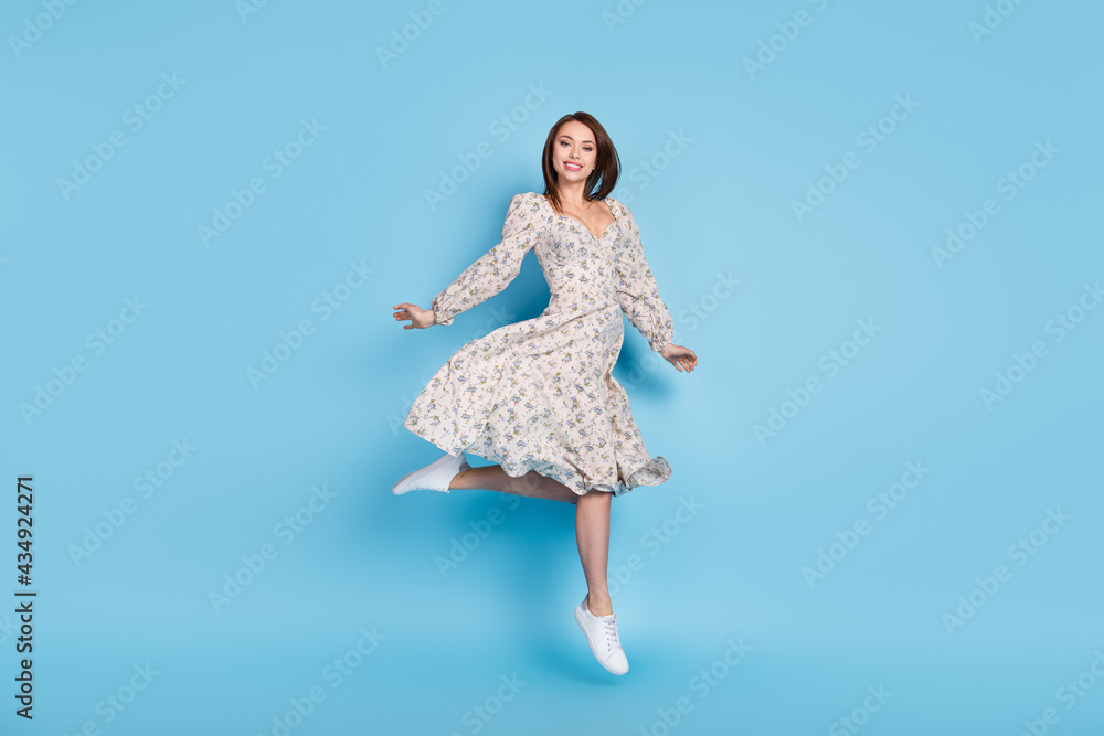 Full size photo of cute brown hairdo young lady jump wear dress isolated on blue background