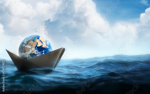 Принти на полотні Earth world in a paper boat floating in the ocean