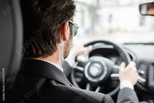 back view of bodyguard driving modern automobile © LIGHTFIELD STUDIOS
