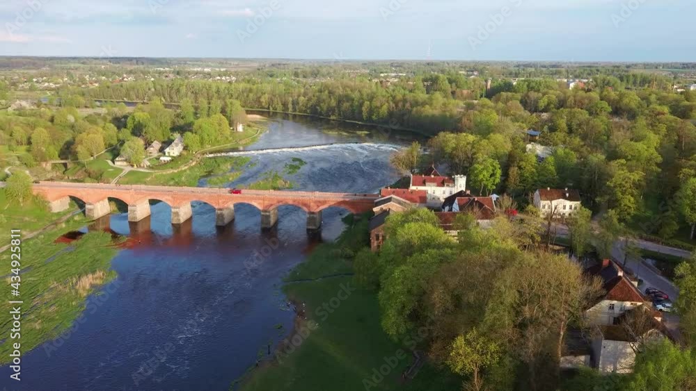 Aerial Shot Flying Towards of the Old Brick Bridge Across the Venta River in Kuldiga, Latvia Aerial Shot Flying Towards of the Old Brick Bridge Across the Venta River in Kuldiga, Latvia