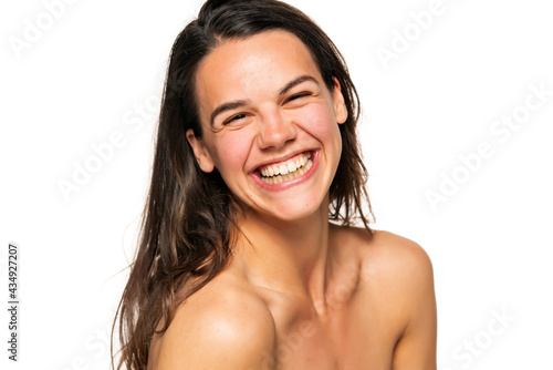Portrait of a young laughing woman without makeup