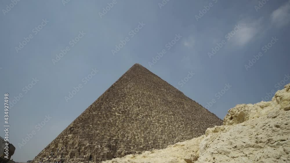 The Great Pyramid in Giza, Cairo against the clear summer blue sky. Vacation and travel in Egypt concept The Great Pyramid in Giza, Cairo against the clear summer blue sky. Vacation and travel in Egypt concept