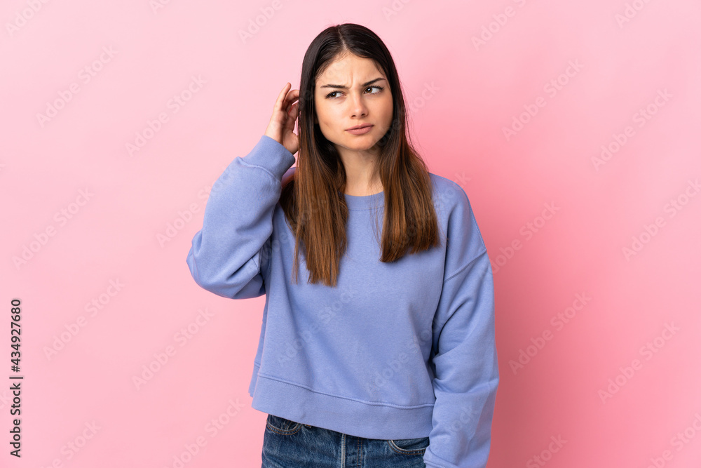 Young caucasian woman isolated on pink background having doubts Young caucasian woman isolated on pink background having doubts