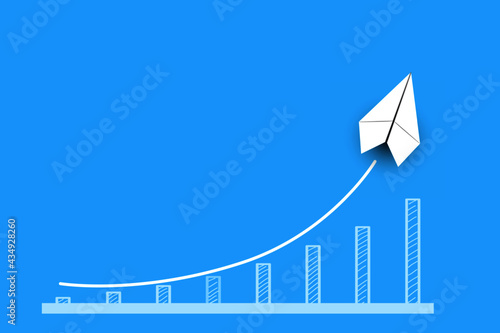 White paper airplane with growing sketch graph on blue background, growth and successful concept.