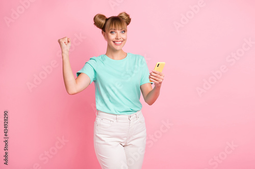 Portrait of cheerful lady fist up toothy smile celebrate good mood wear turquoise isolated on pink color background