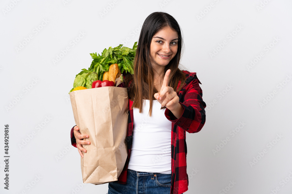 Young caucasian with vegetables isolated on white background showing and lifting a finger Young caucasian with vegetables isolated on white background showing and lifting a finger