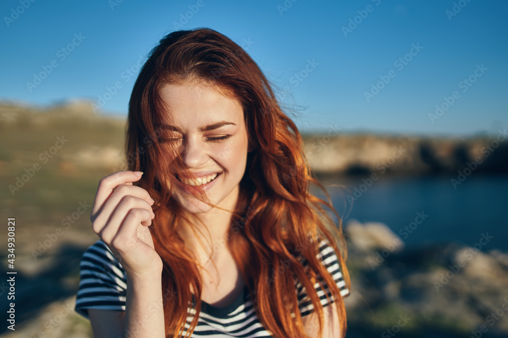 happy woman on vacation in nature in the mountains near the river fun emotions