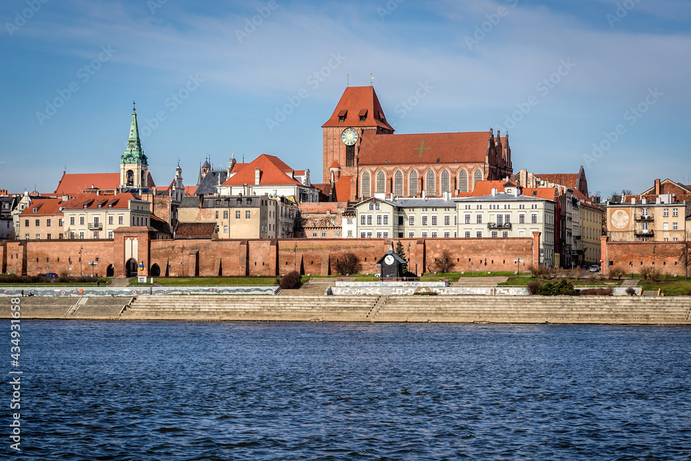 Obraz premium Cathedral and Holy Spirit church tower, historic part of Torun city over Vistula River, Poland