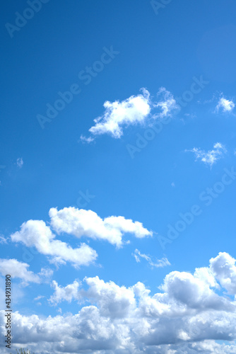 Blue sky and old clouds in summer. Vertical snapshot. Space for text