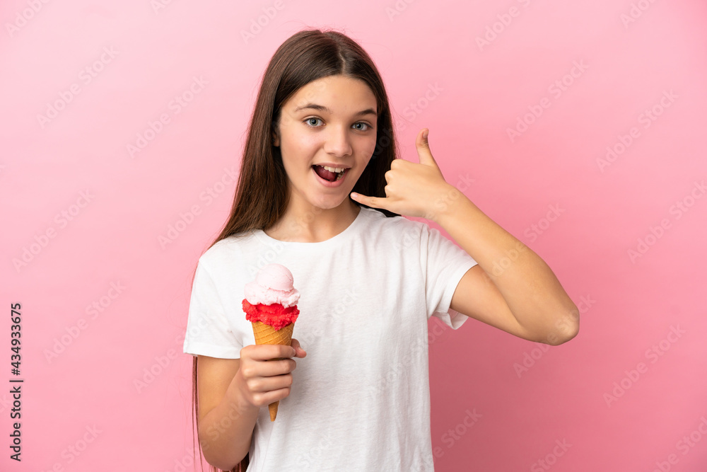 Little girl with a cornet ice cream over isolated pink background making phone gesture. Call me back sign Little girl with a cornet ice cream over isolated pink background making phone gesture. Call me back sign