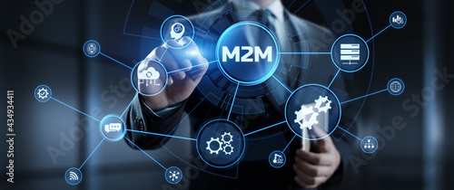 M2M Machine to machine industrial technology concept. Businessman pressing button