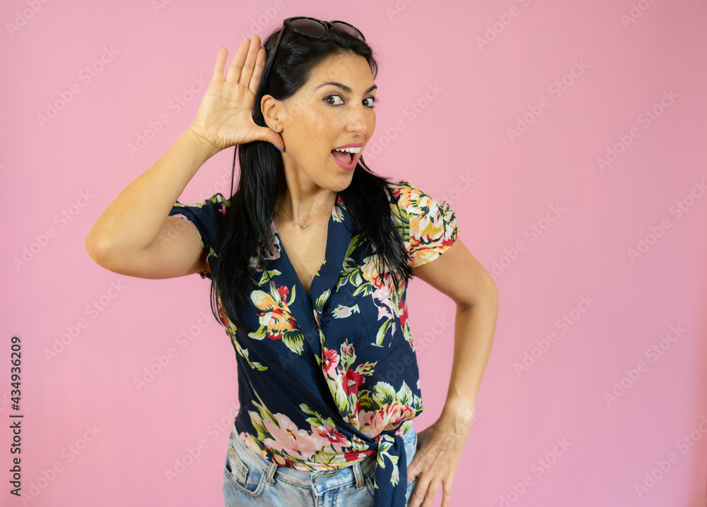 Young beautiful hispanic woman wearing casual clothes smiling with hand over ear listening an hearing to rumor or gossip. deafness concept. Young beautiful hispanic woman wearing casual clothes smiling with hand over ear listening an hearing to rumor or gossip. deafness concept.