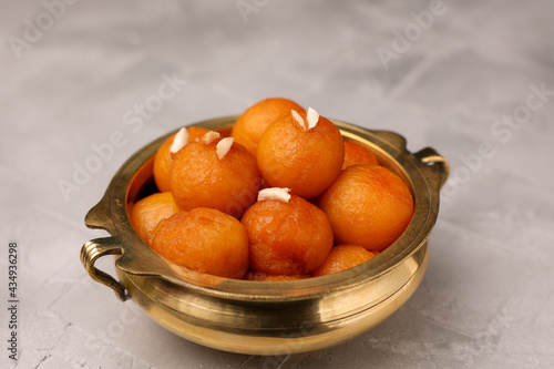 Gulab jamun , gulaab jamun in sugar syrup golden bowl Indian sweet food mithai Egyptian Zalabia balls dessert fried delicacy in honey Pakistan, India, Sri Lanka, Kerala, Arab on Ramadan Diwali  photo