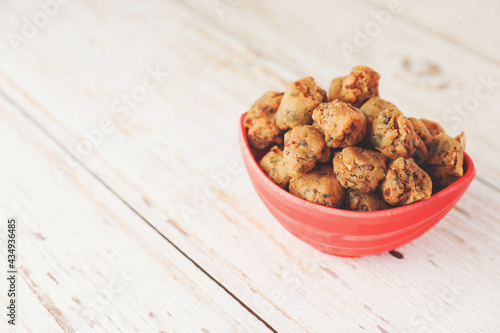 Indian traditional snack spicy Pakoda on wooden table	
 photo