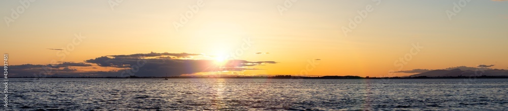 White Rock, Greater Vancouver, British Columbia, Canada. Colorful and Vibrant Panoramic View of a cloudy and colorful sunset over the Pacific Ocean Coast. Nature Background Panorama