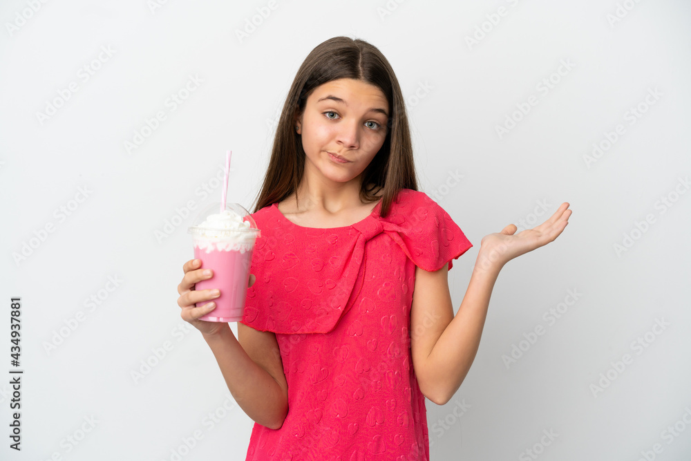 Little girl with strawberry milkshake over isolated white background having doubts while raising hands Little girl with strawberry milkshake over isolated white background having doubts while raising hands