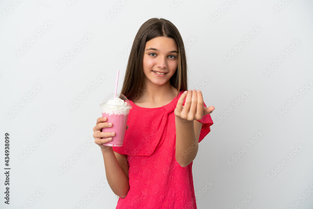 Little girl with strawberry milkshake over isolated white background inviting to come with hand. Happy that you came Little girl with strawberry milkshake over isolated white background inviting to come with hand. Happy that you came