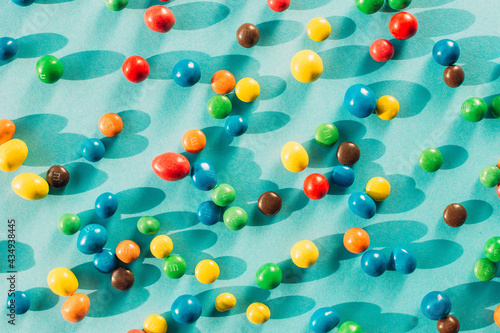 Chocolate multicolored candy dragee on a blue background