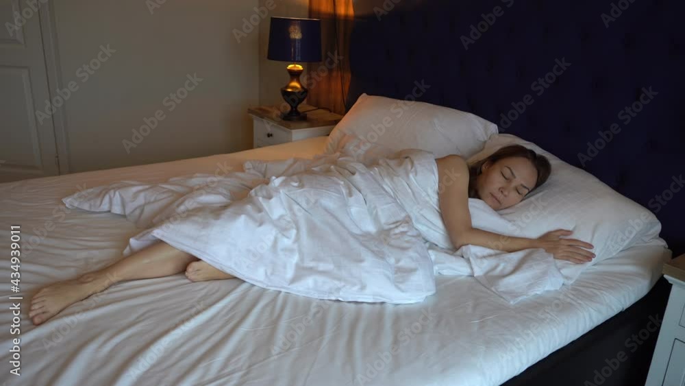 Female waking up. Young woman opens her eyes in luxury hotel bed. Happy young woman awake after healthy sleep on comfortable mattress, smiling girl fresh full of energy enjoying good morning get up. Female waking up. Young woman opens her eyes in luxury hotel bed. Happy young woman awake after healthy sleep on comfortable mattress, smiling girl fresh full of energy enjoying good morning get up.