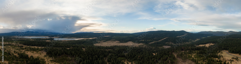 Aerial Panoramic View of a Lake in the Canadian Landscape. Cloudy and Sunny Spring Sunset. Taken near Kamloops and Merritt, British Columbia, Canada. Tunkwa Lake