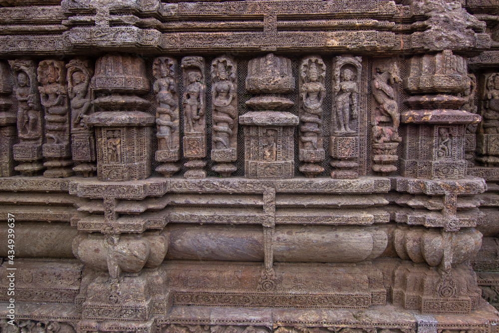 Ancient sandstone carvings on the walls of the ancient 13th-century CE Konark sun temple in Odisha , India.