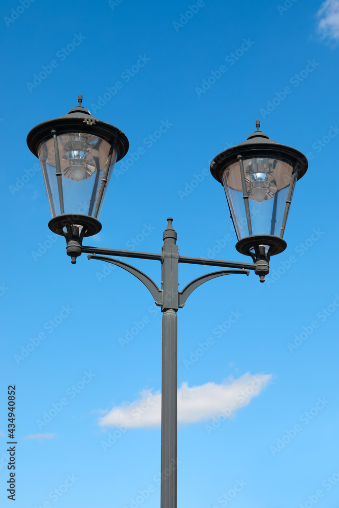 Vintage street lamp isolated against blue sky