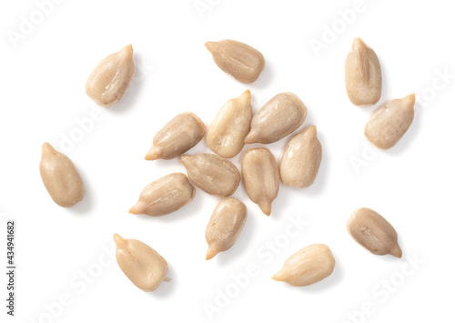 close up of peeled sunflower seeds isolated on white background, top view