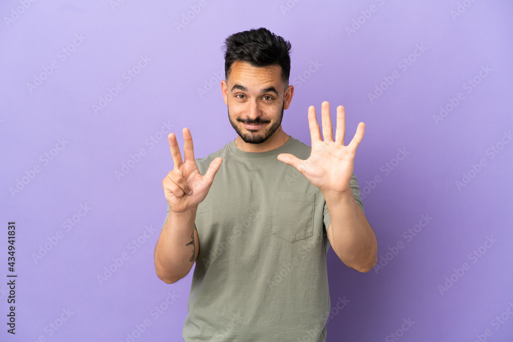 Young caucasian man isolated on purple background counting eight with fingers Young caucasian man isolated on purple background counting eight with fingers
