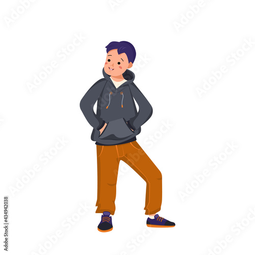 Boy in a hoodie, jeans and sneakers stands and smiles. Happy child holds his hands in the poop. Teenager with face and eyes in casual clothes. World International children day
