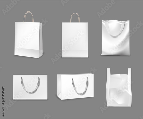 White paper and fabric bags set. Blank gift or shopping packages with handles vector illustration. Realistic commercial store cloth textile and carton bags on gray background