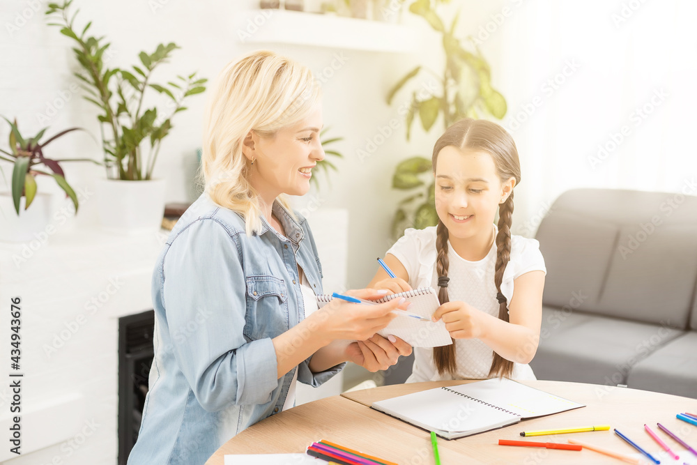 Mother and daughter spending time together at home drawing Mother and daughter spending time together at home drawing