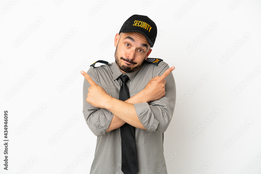 Young security caucasian man isolated on white background pointing to the laterals having doubts Young security caucasian man isolated on white background pointing to the laterals having doubts