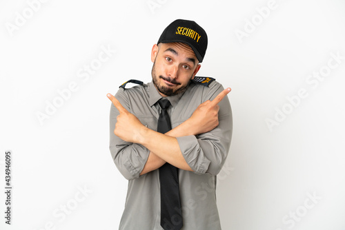 Young security caucasian man isolated on white background pointing to the laterals having doubts