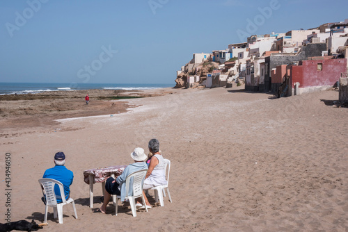 Grupo de turistas sentados en las playas de Tifnit en la costa sur de Marruecos photo