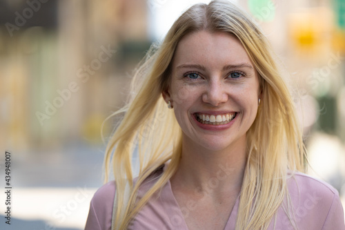 Young caucasian woman in city smile happy face portrait