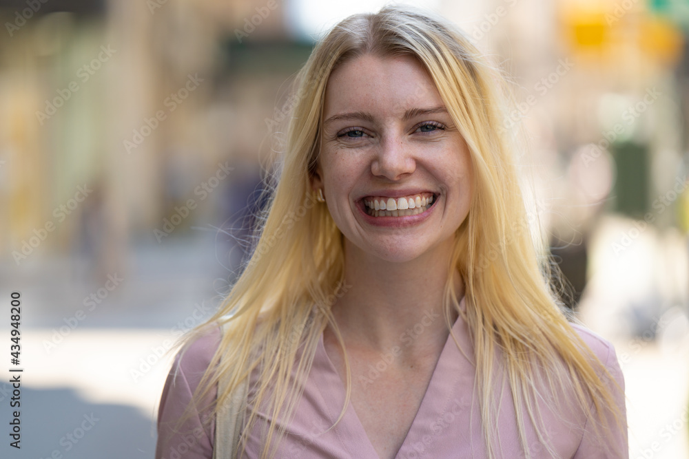 Young caucasian woman in city smile happy face portrait