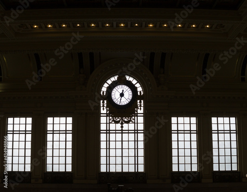 Silhouetted clock and windows of historic train station