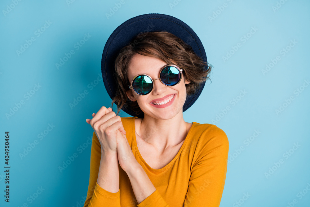 Photo of optimistic nice brunette short hairdo lady hold hands wear spectacles headwear brown shirt isolated on bright blue color background