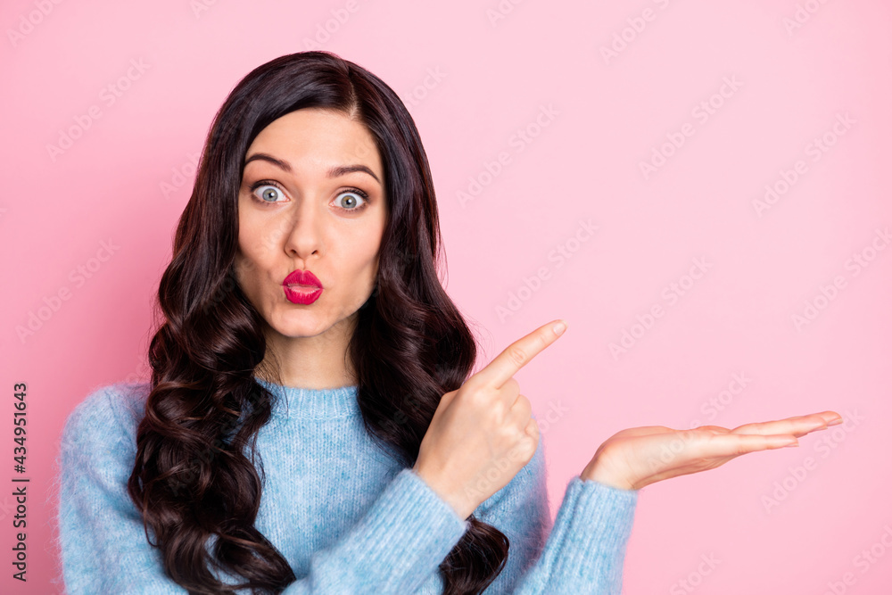 Obraz premium Photo of adorable person kiss lips indicate finger empty space arm palm isolated on pink color background