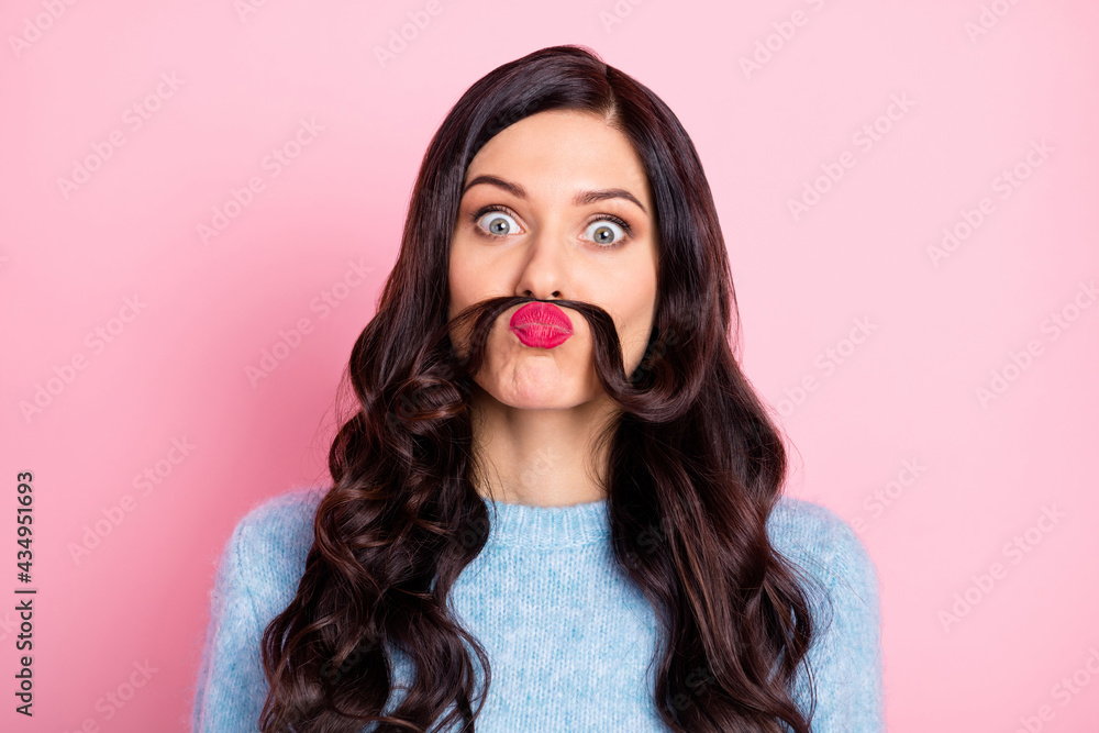 Portrait of satisfied young girl playing make hair mustache wear pullover isolated on pink color background Portrait of satisfied young girl playing make hair mustache wear pullover isolated on pink color background