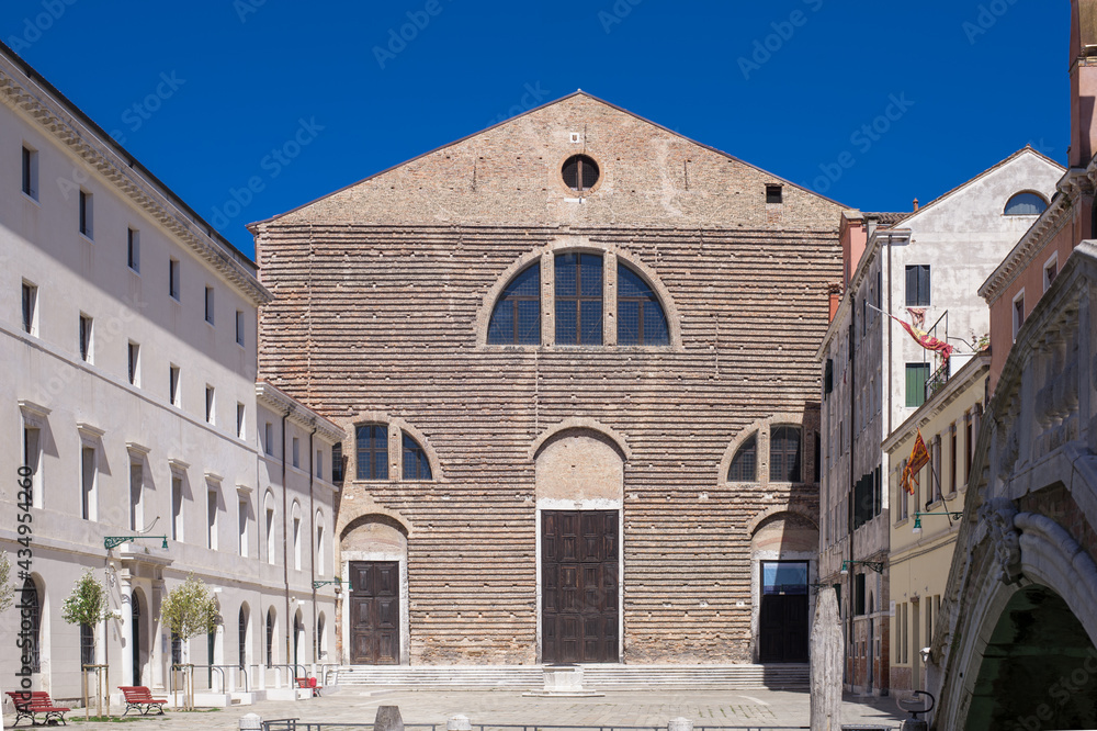 striped facade of a brick building with semicircular windows facing the canal striped facade of a brick building with semicircular windows facing the canal