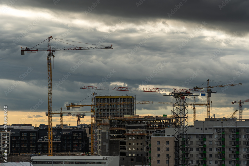 Cranes over construction site for apartment buildings, Helsinki Finland
