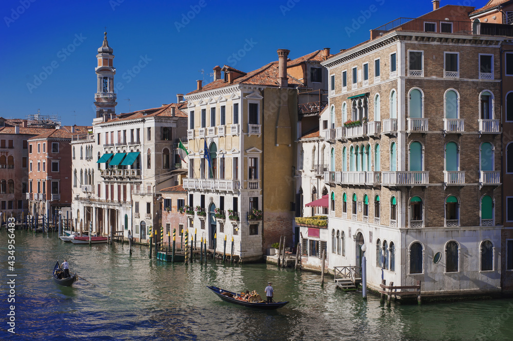 Fototapeta premium facades facing blue clean waters of busy grand canal of Venice