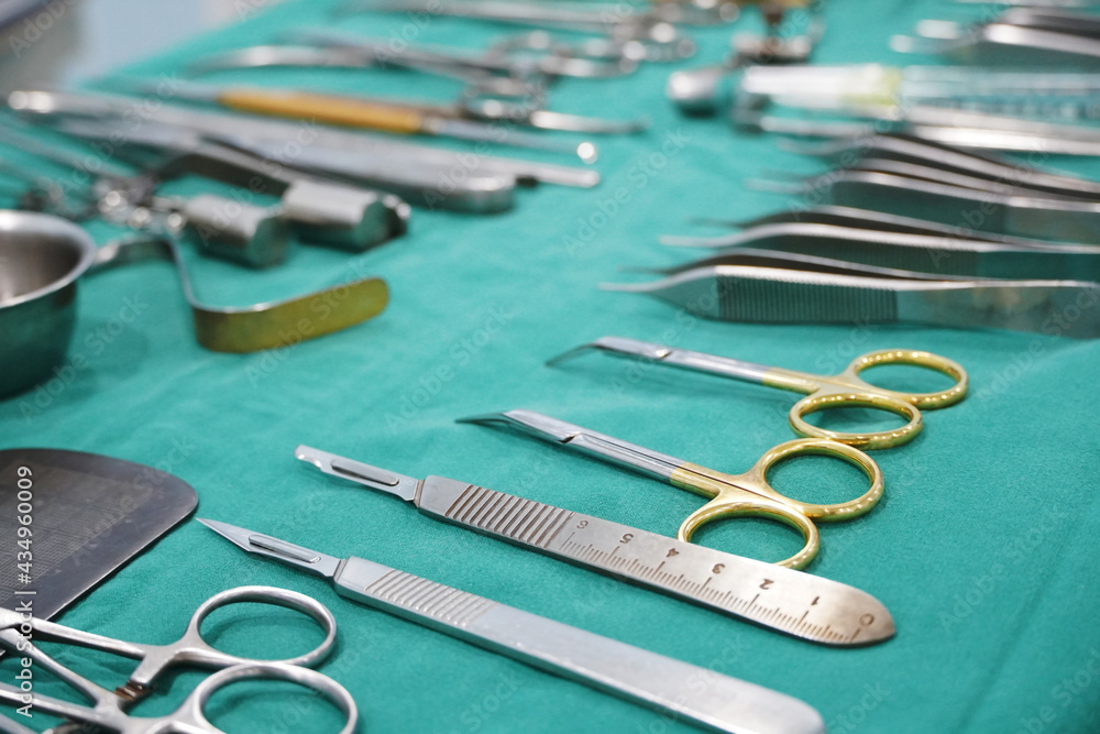 Surgical instruments, surgery, placed on a sterile green cloth, soft focus Surgical instruments, surgery, placed on a sterile green cloth, soft focus