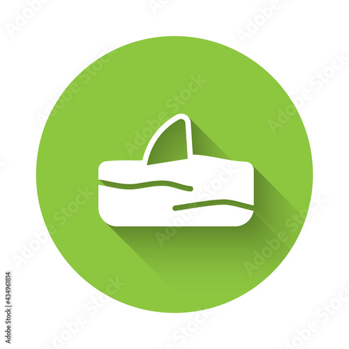 White Shark fin in ocean wave icon isolated with long shadow. Green circle button. Vector