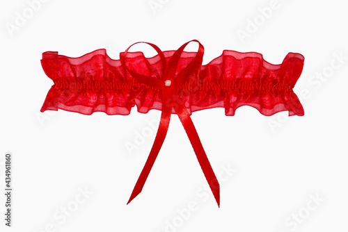 Red lacy wedding garter on a white background. photo