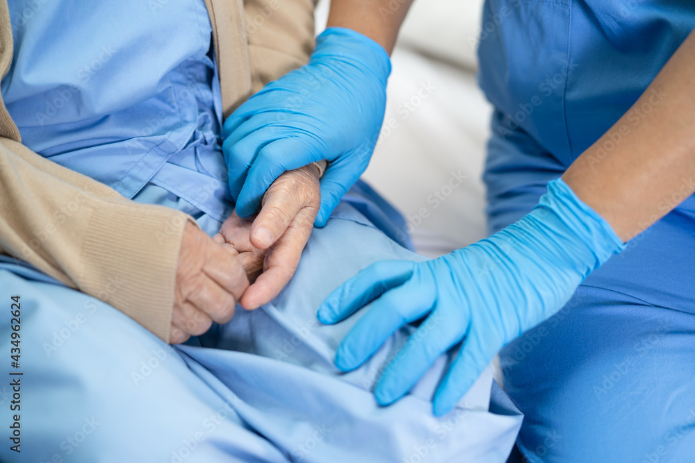 Doctor check and touch with glove Asian senior or elderly old lady woman patient in hospital for protect infection Covid-19 Coronavirus. Doctor check and touch with glove Asian senior or elderly old lady woman patient in hospital for protect infection Covid-19 Coronavirus.