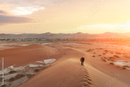 Single man on high dune in the Namib desert
