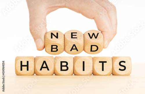 From Bad to new habits concept. Hand turns a wooden blocks with bad to new words